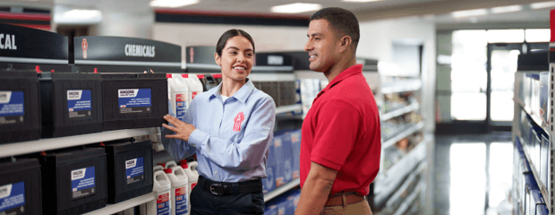 A Kenworth clerk explains a part to a customer in a dealership