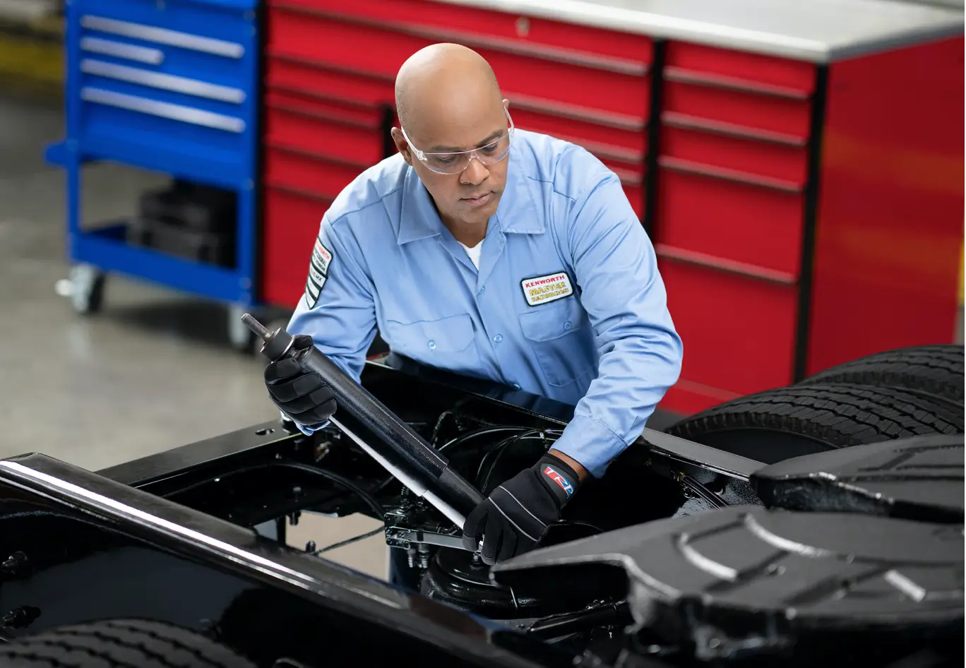 A Kenworth technician services a truck