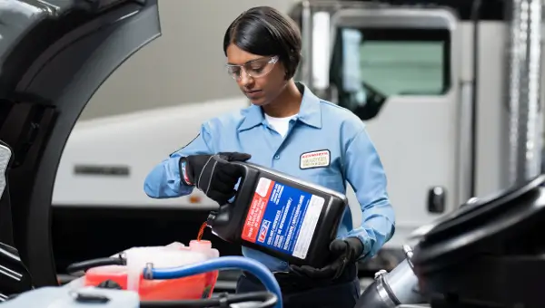 Kenworth service tech filling coolant