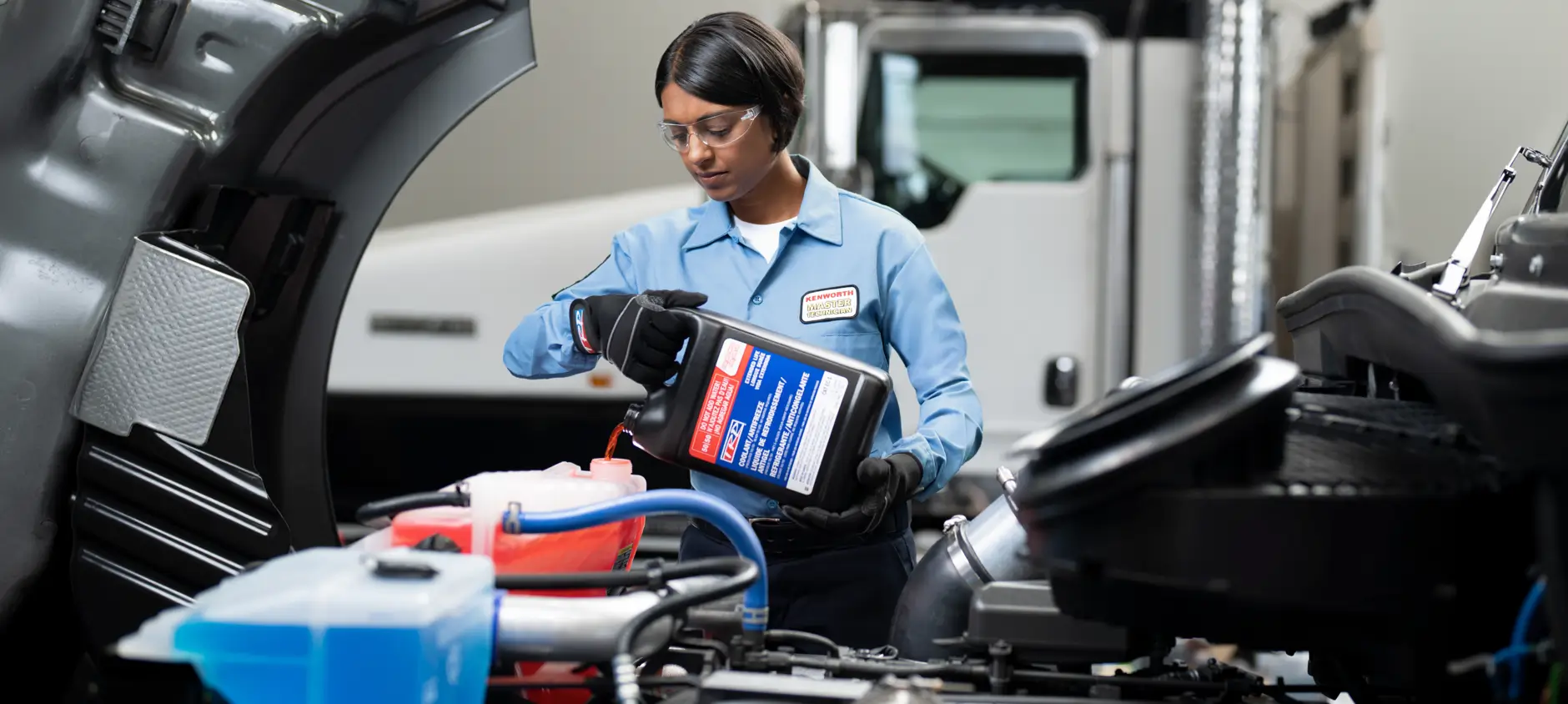 KW service tech pouring coolant